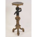 A late 19th century Rococo Revival giltwood and ebonised Blackamoor torchere stand, the cherub