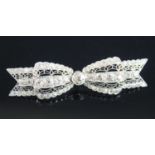 A white metal Art Deco bow brooch, featuring 61 Old European cut diamonds in grain and bezel