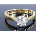 An 18ct yellow and white gold diamond solitaire ring, featuring an Old European cut diamond in an