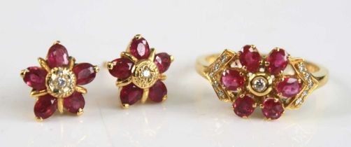 A yellow metal ruby and diamond ring and earring set, the ring designed as a circular cluster with