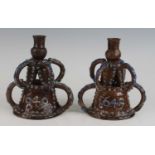 A pair of Edward Bingham of Castle Hedingham brown and blue glazed pottery candlesticks, circa 1890,