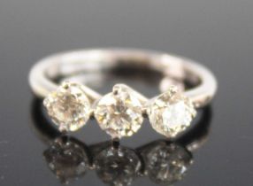 An 18ct white gold diamond trilogy ring, comprising three round brilliant cut diamonds in
