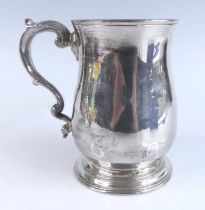 A George II silver bell shape tankard, having plain baluster body with gilt-washed interior and