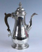 An early George III silver coffee pot, of plain squat baluster form to a stepped circular footrim,