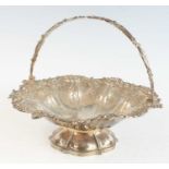 An early Victorian silver swing handle cake basket, of shaped circular form with pierced scrolling
