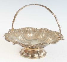 An early Victorian silver swing handle cake basket, of shaped circular form with pierced scrolling