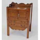 A George III mahogany tray-top night commode, having two drawers above a pull-out base with
