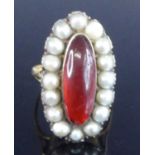 A yellow metal Georgian oval cluster ring, having a centre 18.2 x 6.4mm oval red paste stone