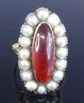 A yellow metal Georgian oval cluster ring, having a centre 18.2 x 6.4mm oval red paste stone