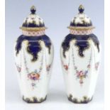 A pair of Royal Worcester vases and covers, circa 1910, each of hexagonal form, decorated with