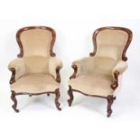 A pair of Victorian mahogany framed spoonback library armchairs, each reupholstered in a beige