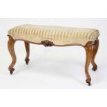 A Victorian walnut framed duet dressing stool in the French taste, having reupholstered stuffover