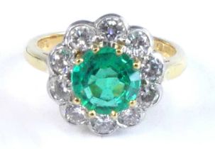 An 18ct yellow and white gold, emerald and diamond circular cluster ring, comprising a centre