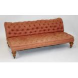 A Victorian settee, the whole button back upholstered in a salmon pink damask and raised on Arts &