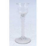 A wine glass, circa 1770, the basal moulded waisted ogee bowl above a single series opaque twist