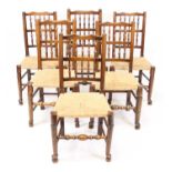 A matched set of eight elm and ash Lancashire spindleback dining chairs, each with rush seats and on