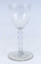 A wine glass, circa 1785, the round funnel bowl above a faceted stem, h.15cm