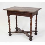 A circa 1700 joined oak single drawer side table, having a planked top and raised on ring turned