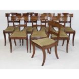 A set of eight Regency mahogany dining chairs, having elegant barbacks, drop-in seats and raised