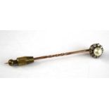 A yellow metal, pearl and diamond stick pin, having a centre 5.9mm cultured pearl within a border of