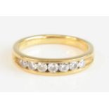 An 18ct yellow gold diamond half eternity ring, having seven round brilliant cut diamonds in a