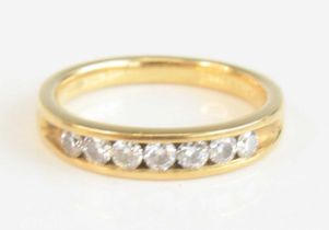 An 18ct yellow gold diamond half eternity ring, having seven round brilliant cut diamonds in a