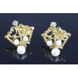 A pair of yellow metal, pearl and diamond earrings, each in the form of an openwork coronet and
