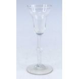 A wine glass, circa 1750, the double ogee bowl above a knopped air twist stem, h.18cm No apparent