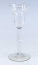 A wine glass, circa 1750, the double ogee bowl above a knopped air twist stem, h.18cm No apparent