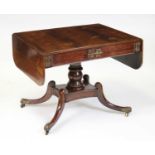 A Regency rosewood and inlaid pedestal sofa table, the frieze having twin blind drawers and brass
