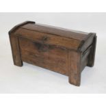A circa 1700 joined oak coffer, of unusual construction, having a domed top on end peg hinges and