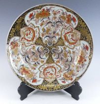 A Japanese Imari porcelain charger, 19th century, decorated with flowers, dia.55cm It ‘rings’ well.