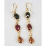 A pair of yellow metal multi-sapphire drop earrings, each with two oval and one pear cut sapphire,