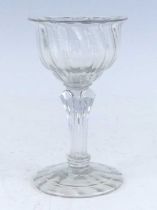 A champagne glass, circa 1745, the wrythen moulded ogee bowl having an everted rim above an eight