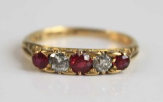 An early 20th century 18ct yellow gold, ruby and diamond half hoop ring, comprising three