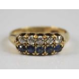 A late Victorian 18ct yellow gold, sapphire and diamond half eternity ring, comprising a row of five