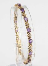 A modern 9ct gold, amethyst and diamond point set bracelet, comprising 15 x 4 claw set oval