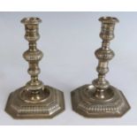 A pair of Elizabeth II silver candlesticks in the Georgian style, the stems of knopped reeded form