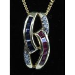 A modern 9ct gold, sapphire, ruby and diamond pendant, comprising six 2mm channel set calibre cut