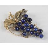 A yellow metal Art Nouveau style sapphire and diamond brooch in the form of a bunch of grapes,