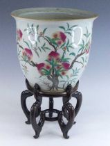 A Chinese porcelain jardiniere, 20th century, enamel decorated with a peach tree, h.34cm, dia.