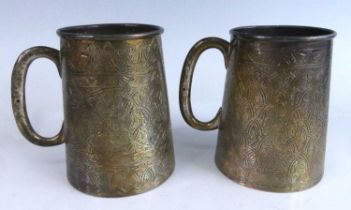 A pair of Egyptian white metal tankards, of stein form with plain applied C handles, all-over