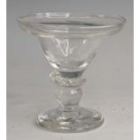 A glass sweetmeat, circa 1730, the pan topped round funnel bowl above a flattened knop and wrythen