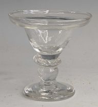 A glass sweetmeat, circa 1730, the pan topped round funnel bowl above a flattened knop and wrythen