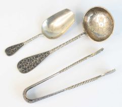 A 19th century Russian silver and niello three-piece tea flatware set, comprising tea scoop, tea