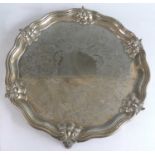 A large early Victorian silver salver, of shaped circular form with raised reeded and contoured rim,