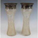A pair of crystal and silver vases, of waisted form, the silver rims relief decorated with swags and