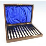 A cased set of six Edwardian silver and mother of pearl handled fruit knives and forks, the ferrules