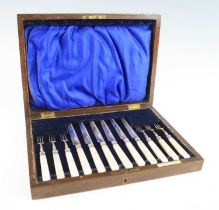 A cased set of six Edwardian silver and mother of pearl handled fruit knives and forks, the ferrules