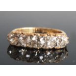 A late 19th century yellow metal five-stone half eternity ring, having five Old European cut